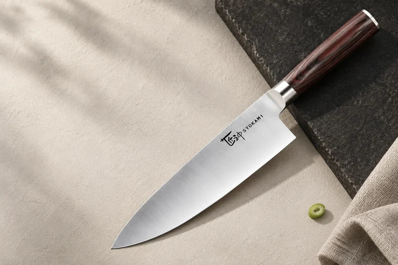 SYOKAMI chef knife on linen and warm stone