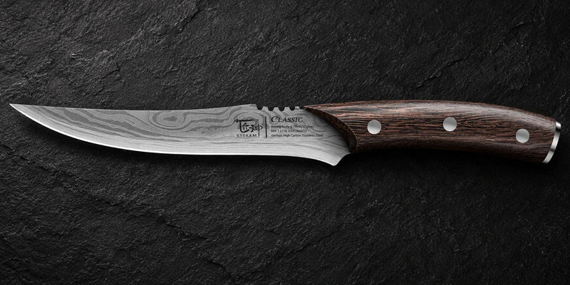 Complete side profile of one curved pointed boning knife with a dark wooden three-rivet handle and blade markings on black stone