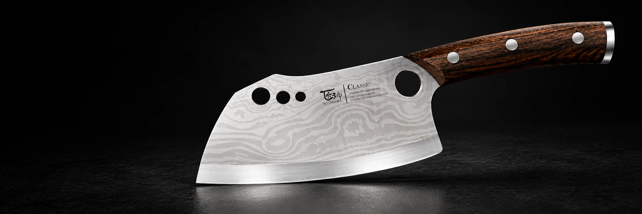 SYOKAMI Artsy knife with its engraved blade and wooden handle on black stone